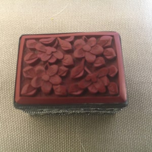 Charming two piece tiny box of carved top and worked silver