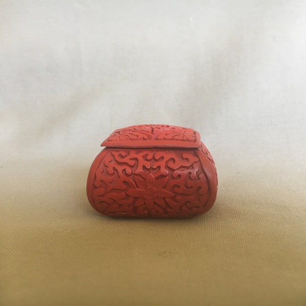 Carved, two piece box, carnelian lacquer with turquoise enameled interior