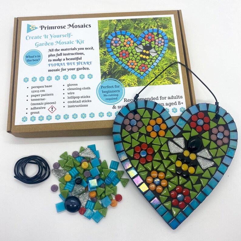 May include: A floral bee heart mosaic kit with all the materials needed to create a mosaic. The kit includes a 6-inch perspex base, mosaic tiles, adhesive, grout, lollipop sticks, cocktail sticks, wire, gloves, and instructions. The finished mosaic is a heart shape with a bee and flowers.