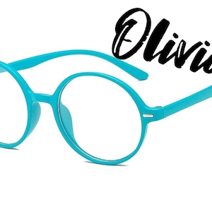 May include: Blue round glasses with a silver accent on the side. The glasses are on a white background with the word "Olivia" written in black cursive.