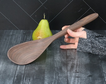 Extra large walnut wood cooking spoon. Angled bowl and long handle for deep pot stirring and serving.