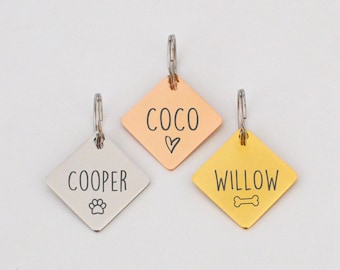 May include: Three diamond-shaped dog tags with personalized names: Coco, Cooper, and Willow. Each tag features a small symbol: a heart, a paw print, and a bone.