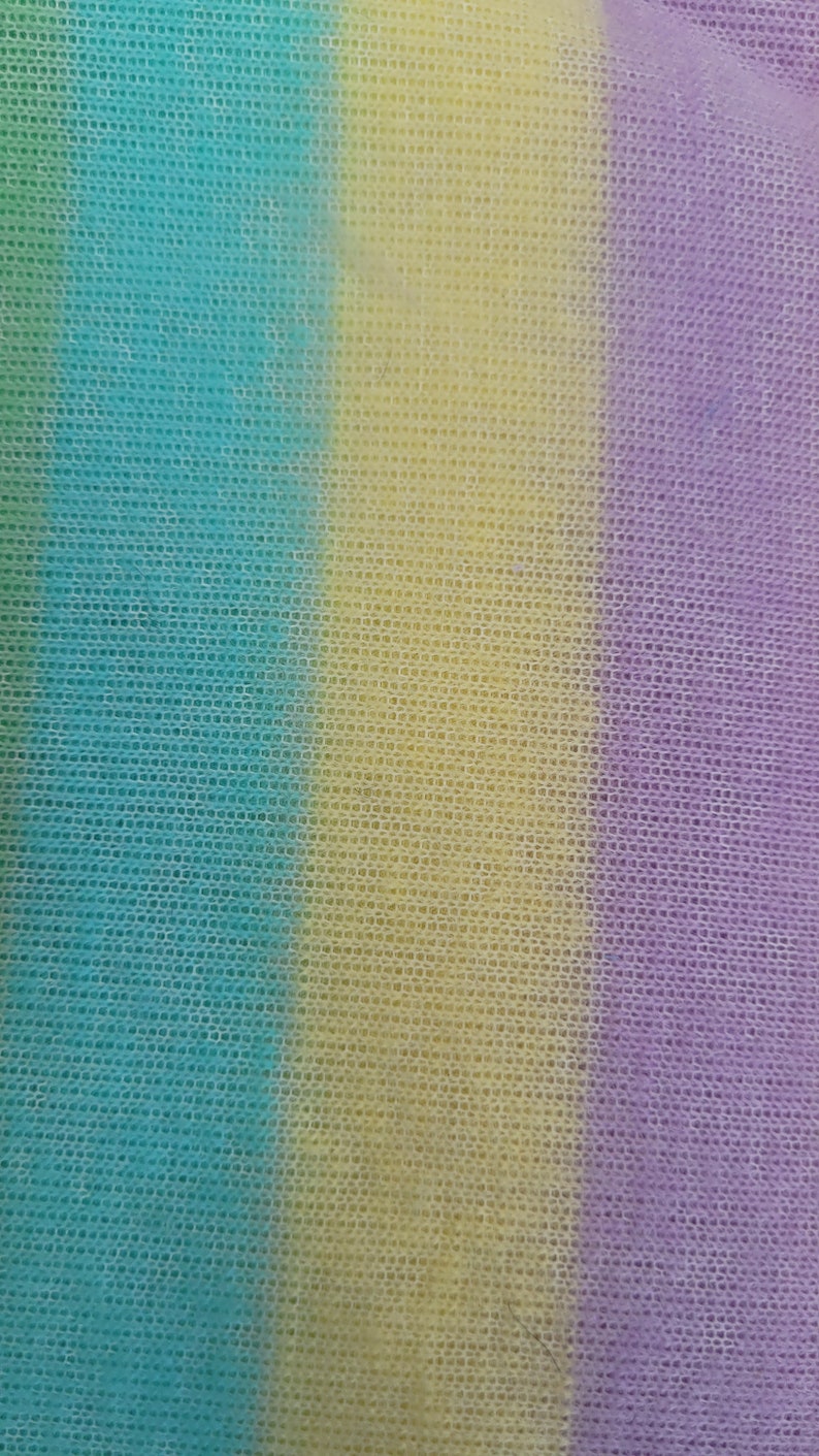 May include: A striped fabric with three vertical stripes in shades of teal, yellow, and purple.