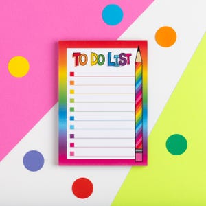 May include: A to-do list notepad with a rainbow-striped pencil design. The notepad is on a pink, white, and green background with colorful circles.