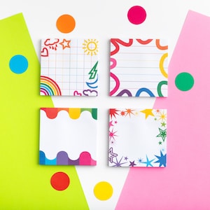 May include: Four square sticky note pads with colorful designs. One pad features a rainbow, sun, and lightning bolt. Another has a wavy rainbow border. The third has a star border, and the fourth has a colorful swirl border.