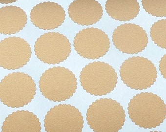 May include: A sheet of metallic gold, scalloped-edge stickers. The stickers are arranged in rows and columns on a white background. The stickers are a warm, bronze colour and are on a white sheet of paper.