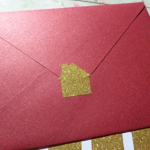 May include: A red envelope with a gold glitter house sticker.