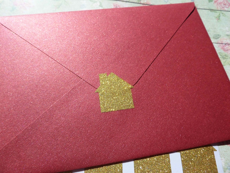 May include: A red envelope with a gold glitter house sticker.