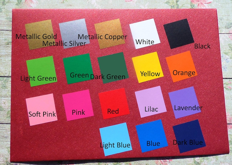 May include: A color chart with 18 different color swatches. The swatches are arranged in three rows of six. The colors include metallic gold, metallic silver, metallic copper, white, black, light green, green, dark green, yellow, orange, soft pink, pink, red, lilac, lavender, light blue, blue, and dark blue.