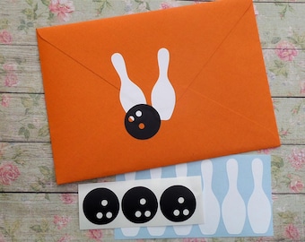 May include: An orange envelope featuring a bowling theme. The envelope has a white bowling pin and black bowling ball sticker. Additional bowling ball and pin stickers are also visible.