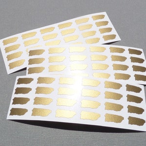 May include: Three sheets of gold foil stickers featuring the outline of Puerto Rico. Each sheet has 12 stickers.