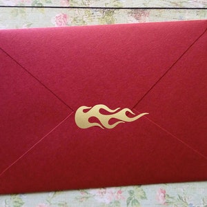 May include: Red envelope with a gold flame design.