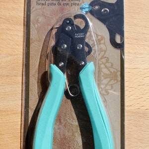 May include: A turquoise and black 1-step looper tool for trimming and looping head pins and eye pins. The packaging features the text "VINTAJ 1-STEP LOOPER" and "PRO QUALITY".