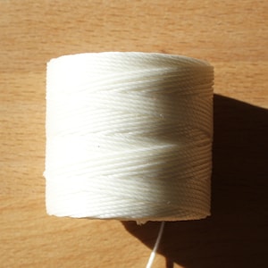 May include: A spool of white cotton twine.