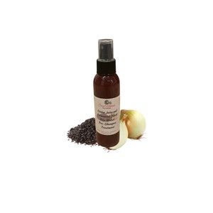 May include: A brown bottle with a spray nozzle, labeled "Onion Juice and Fermented Black Rice Water Pre-Shampoo Treatment" by "Sweet Naturals Hair & Body". The bottle is next to a white onion and a pile of black rice.