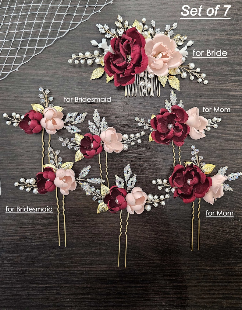 May include: Set of seven burgundy and blush floral hair combs and pins with gold accents, pearls, and rhinestones. The set includes one comb and six pins. The text "Set of 7" and "for Bride" are visible in the image.
