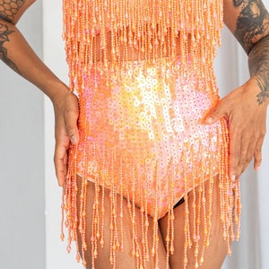 Sunset orange sequin booty shorts. Perfect for festival outfit and sparkly rave wear. Great for pole dance wear and burlesque costume. image 1