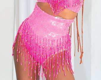 Neon pink sequin booty shorts for women. Perfect festival outfit or sparkly rave wear.