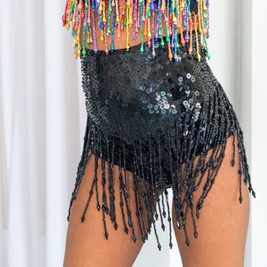 Flat black sequin booty shorts for women with beads. Perfect festival outfit, sparkly rave and party wear.