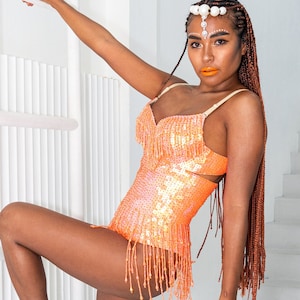 Sequin bodysuit for women in orange glitter. This sequin leotard is perfect for festival outfit, rave wear, glamorous party wear.