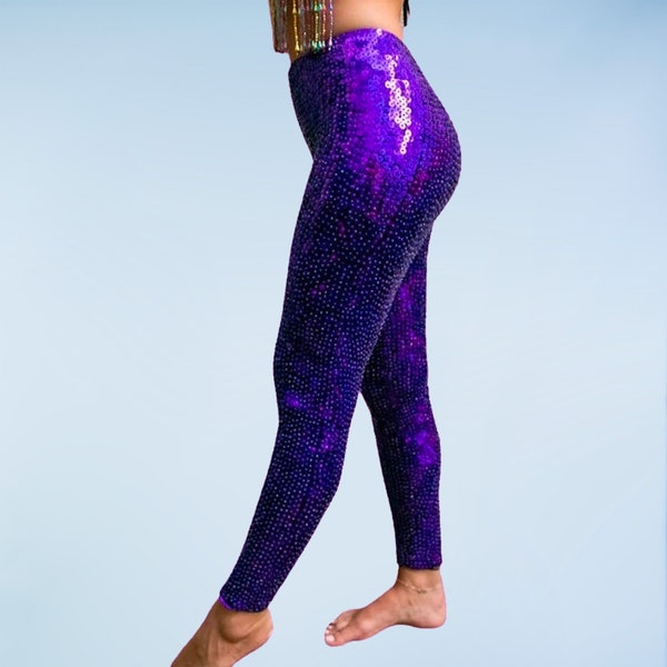 Sparkly disco pants in purple sequins for women and men. Purple sequin leggings perfect for festival wear, rave outfit and stage costumes.