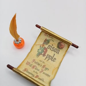 May include: A rolled up scroll with a gold background and brown wooden ends. The scroll has a printed image of a red apple and the text "Poison Apple" and "Victim's Eyes Will Close Forever in the Sleeping Death".
