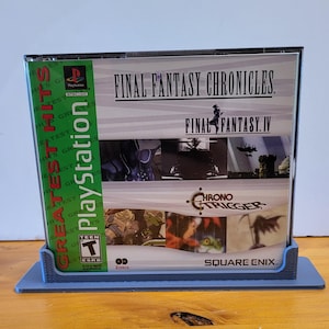 May include: A PlayStation Greatest Hits game case for Final Fantasy Chronicles, featuring Final Fantasy IV and Chrono Trigger. The case is green and blue with the PlayStation logo and a Teen rating. The back of the case shows screenshots from the games and the Square Enix logo.