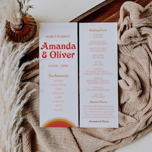 Puede incluir: Un programa de boda con un diseño de arcoíris colorido. El programa enumera la fiesta de bodas, el orden de la ceremonia y agradecimientos especiales. El texto dice "Bienvenido a la boda de Amanda y Oliver".