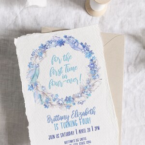 May include: A blue and white invitation card with a watercolor wreath of snowflakes and feathers. The text reads "for the first time in four-ever!" and "Brittany Elizabeth is turning four!"  Join us Saturday, April 20, 2 PM. Brittany's Ice Castle, 123 4th St., City, State 12345. RSVP to Aimee 123.456.7890. Aim Beth Designs.