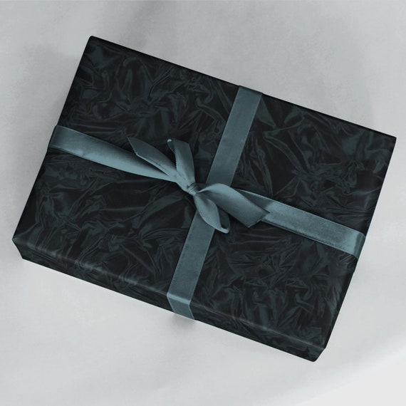 Premium Photo  Gift box wrapped in black paper with silver ribbon on  wooden surface