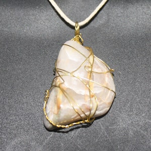 Wire wrapped stone pendant with adjustable hemp cord