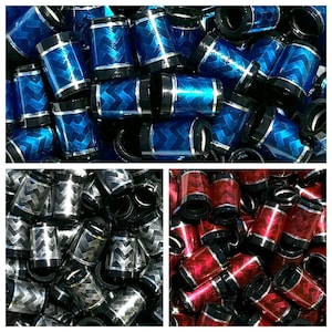 May include: Assortment of golf club head covers in three different colors: black and silver, blue and silver, and red and silver. Each cover has a chevron pattern.