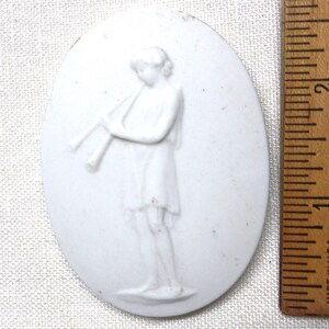 Vintage bisque embellishment tile: An Etruscan or Roman double flute player dated 1972