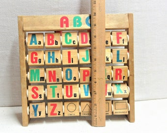 Vintage wooden children's learning toy blocks. Letter blocks reverse to coordinating charactors such as D for dog, etc. Good used condition