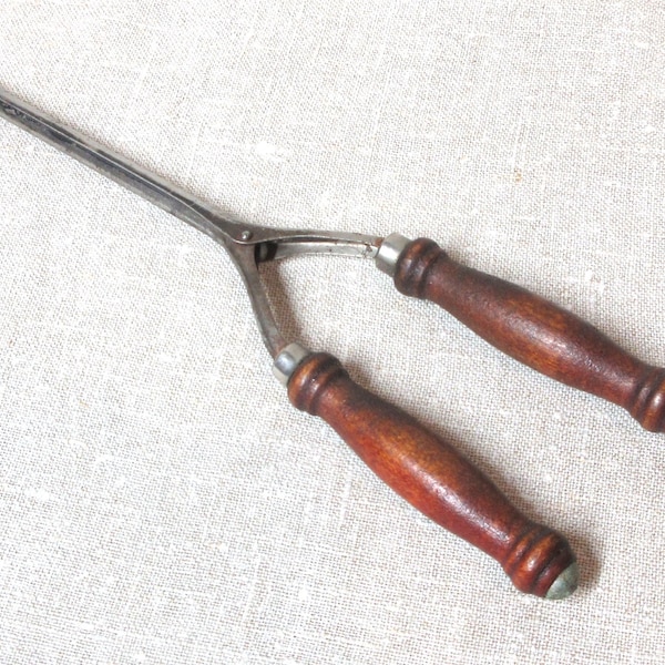 Vintage Hair Crimping Tool. Vintage Curling iron curled hair in a primitive way. Measures 9" long. Wooden handles. Spring closed. Has rust