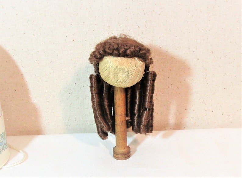 Reddish brown synthetic hair with sausage spiral or ringlet curls and braids. Doll wig Made in Korea Kemper Originals doll wig size 89