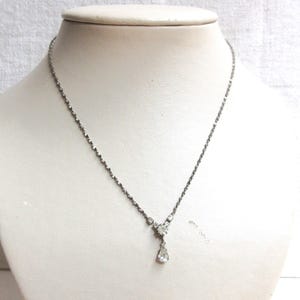 Avon white rhinestone pendant necklace in good used condition. 16&quot; silver plated chain.