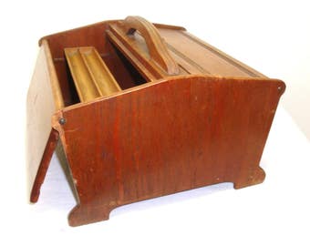 Wood sewing box. Double top doors hinge open to large interior, sliding accessory tray for spools etc. Some wood loss, nicks, scratches