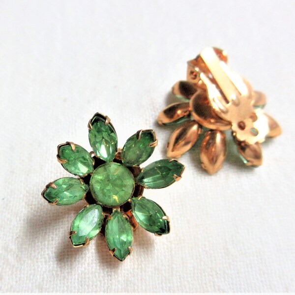 Floral clip on earrings with prong set green marquis stones. About 1". Good used condition