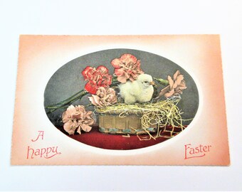 Antique unused  Easter postcard from the 1910s. Depicts chicken in a basket. Made by Valentine & Sons, A little foxing but no bends or tears