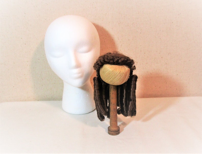 Reddish brown synthetic hair with sausage spiral or ringlet curls and braids. Doll wig Made in Korea Kemper Originals doll wig size 89