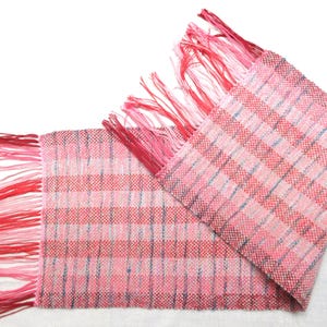 Handwoven red table runner center piece. Striped cotton warp with synthetic art yarn weft. It is 33&quot; total length by 9&quot; wide.