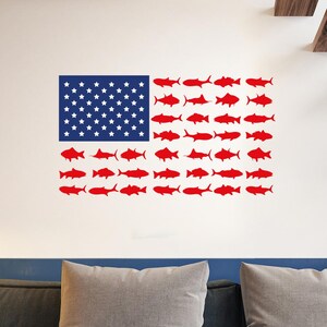 May include: A wall decal featuring an American flag design. The flag's stars are represented by white stars on a blue background. The stripes are replaced with red fish silhouettes, creating a unique patriotic theme.