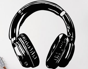 May include: Black and white silhouette of a pair of headphones on a white wall. The headphones are large and have a classic design. There is a guitar and a chair in the background.