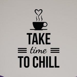 May include: Black and white wall decal with a coffee cup and the text "TAKE time TO CHILL". The decal is on a white wall with two purple chairs in front of it.