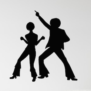 May include: Silhouette wall decal of a couple dancing in a 1970s disco style. The man is wearing a suit and the woman is wearing a pantsuit. The decal is black and is shown on a white wall.