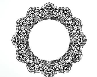 May include: A black and white mandala wall decal with a circular design. The decal is applied to a white wall in a room with a black leather chair.