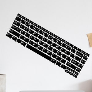 May include: A black and white keyboard silhouette on a white wall. The keyboard is tilted at an angle, with the keys facing the viewer. The keys are labeled with letters, numbers, and symbols.