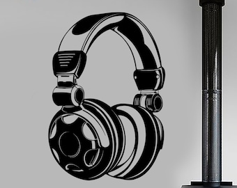 May include: Black and white illustration of a pair of headphones on a white wall. The headphones are large and have a detailed design. The illustration is in a living room setting with a fireplace, a couch, and a chair.