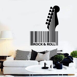 May include: Black and white wall decal of an electric guitar with a barcode and the text "Rock & Roll".